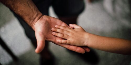 father and child s hands together