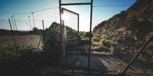 metal net fence in countryside in sunlight