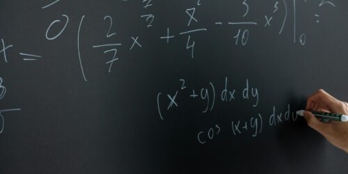 mathematical equation written on blackboard