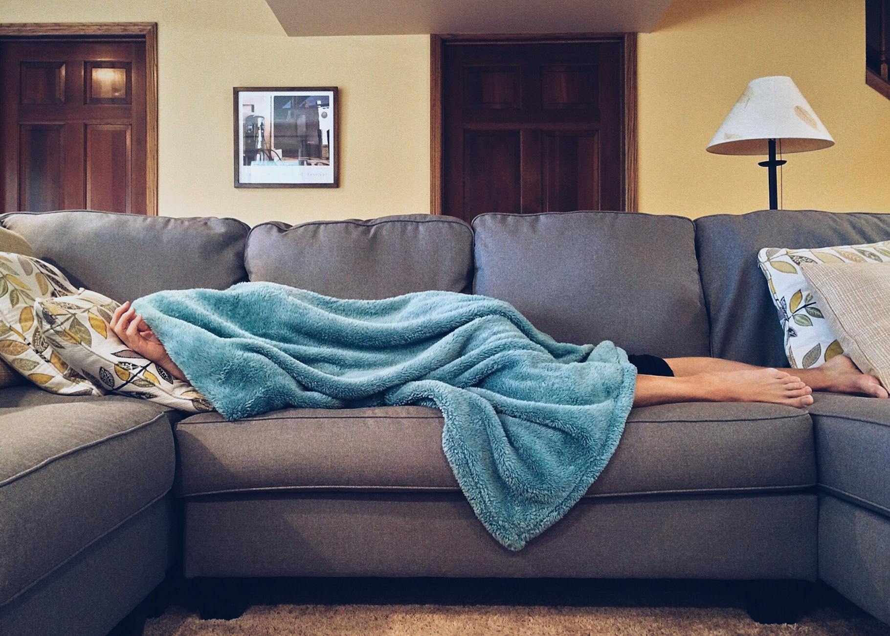 person lying on sofa